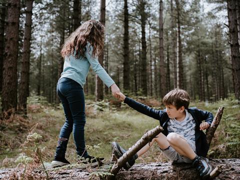 Children helping each other in nature