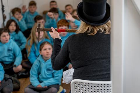 Children on board the Goathland Learning Coach listening to a talk.