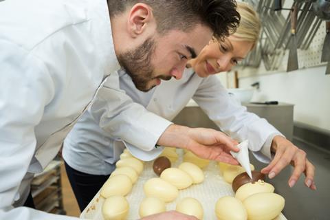 A chocolatier in France decorating Easter eggs