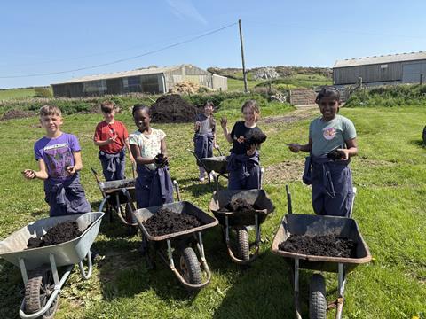 St Woolos Primary School students with wheelbarrows at Treginnis Farm