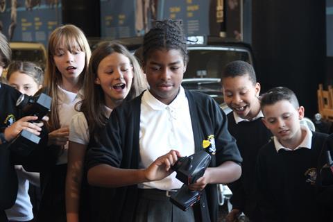 Primary school children doing hands-on activity at museum
