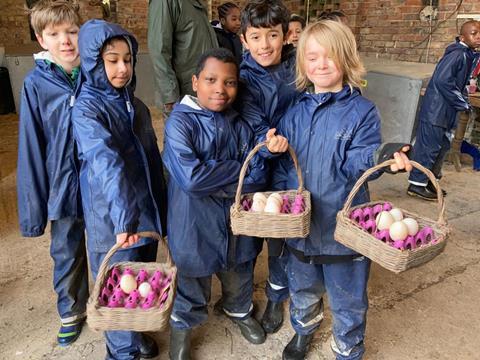 Children collect eggs during a stay at one of the Farms for City Children farms